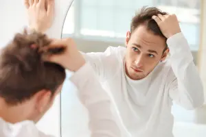 Hair loss troubles - Hair 4 Life Medical Patient inspecting his hairline