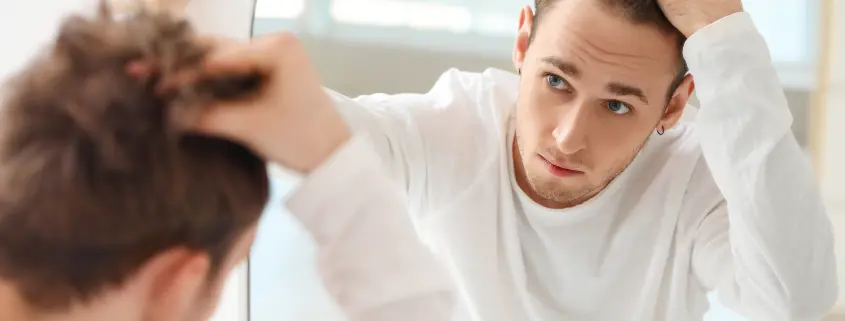 Patient inspecting his hairline